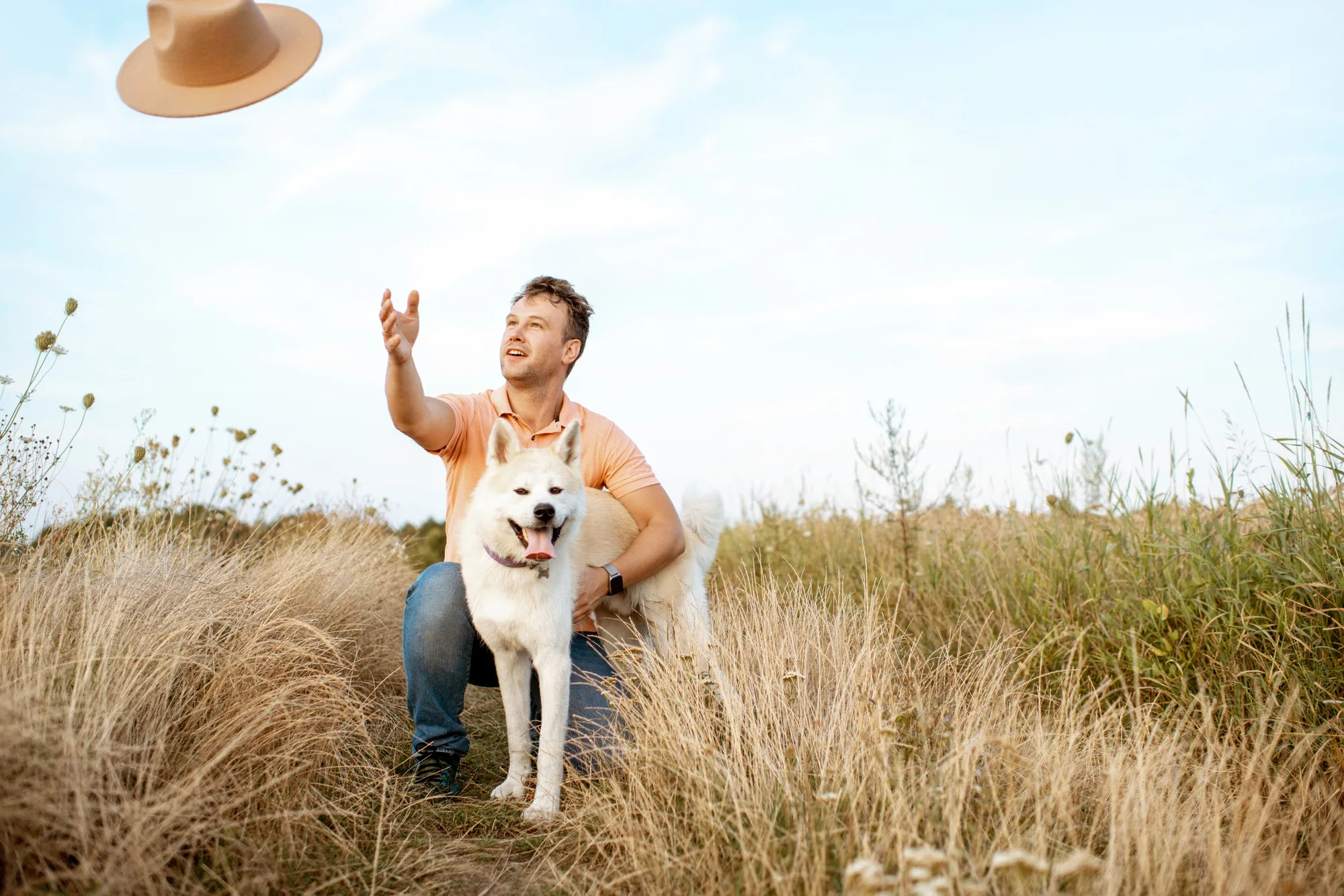 Happy man playing with dog on the field